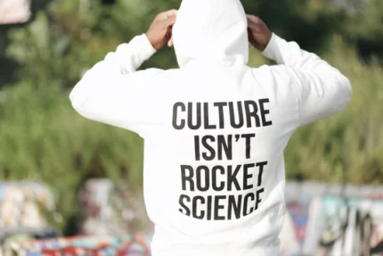 Stay cozy and make a statement with the 'Culture Isn't Rocket Science' Astronaut Hoodie, 8.5oz – a perfect blend of comfort and style.