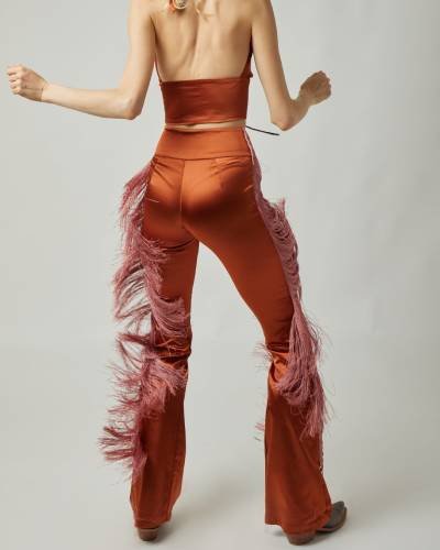 Elevate your style with the Dolly Fringe Pant in Dark Orange, a chic and trendy addition to your wardrobe. These pants feature fringe detailing, adding a touch of flair to your look in a bold and sophisticated dark orange hue.