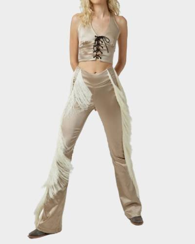Introducing the Dolly Fringe Pant, a chic and trendy addition to your wardrobe. These stylish pants feature playful fringe detailing, making them a perfect choice for a bold and fashionable look that stands out.