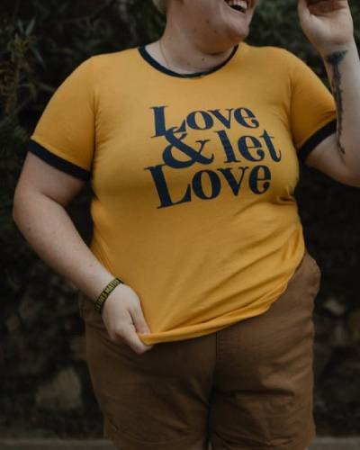 Love & Let Love Shirt in Mustard, a vibrant and positive fashion statement promoting love and acceptance.