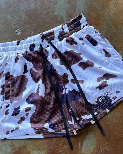 Moo Thai Shorts with mid-thigh cut in a playful brown cow design - a unique blend of style and performance.