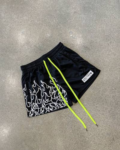 Muay Thai Flame Shorts with mid-thigh cut in striking black and white - fiery style for intense training.