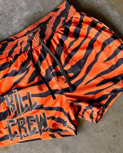 Muay Thai Shorts with mid-thigh cut in a fierce tiger design - perfect for combat training and style
