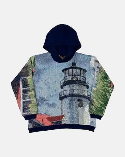 The Lighthouse tapestry hoodie, a beacon of solace amidst turbulent seas, guiding hearts with steadfast grace.