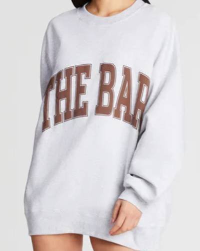 Light heather grey and chocolate varsity-style sweatshirt, a cozy yet stylish addition to any wardrobe.
