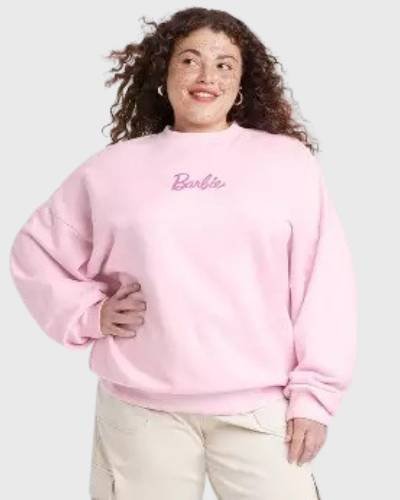 Pink women's sweatshirt featuring Barbie X Skinnydip photographic design, a trendy fashion statement.